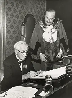 Humourist: A. P. Herbert signing an official document