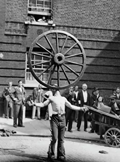 Cartwheel: An acrobat balances a cartwheel on