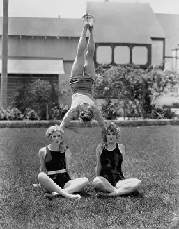 Supportive: Acrobat balancing on womens shoulders
