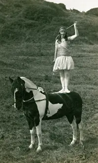 Patched: Acrobat of Sangers Circus standing on a horse