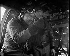 Actor Clark Gable Firing A Machine Gun Out of a Warplane