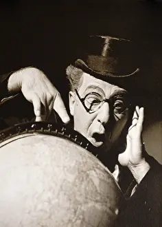 Talkies: Actor Ed Wynn poses behind a globe of earth