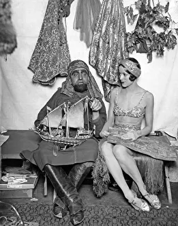 Backstage: Actors in costume with a model boat, 1927