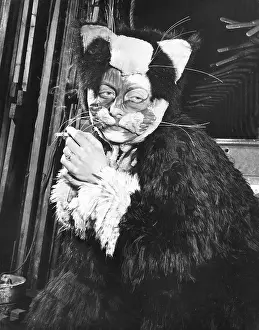Panto: Actress Freda Wyn relaxing in cat costume during a pantomime
