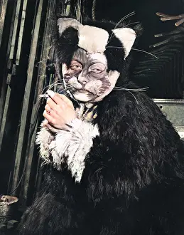 Panto: Actress Freda Wyn relaxing in cat costume during a pantomime