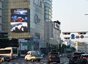 Intersection: Advert for K-Pop boyband IKON above a busy intersection