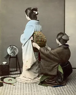 Adjusting: Adjusting an obi sash, Japan