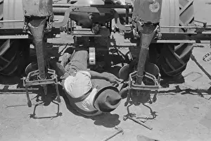 Planter: Adjusting plow points on tractor-drawn planter, large farm n