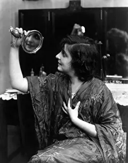 Conceited: Admiring her reflection