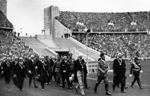 Enters: Adolf Hitler opens the Olympic Summer Games in Berlin, 1