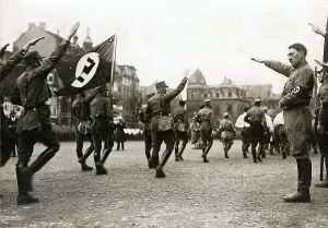 Salutes: Adolf Hitler saluting marching SA, Brunswick