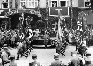 Salutes: Adolf Hitler takes a parade of the SA, 1936