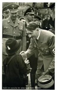 Germanys: Adolf Hitler talking to a child at a Rally