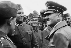 Accompanies: Adolf Hitler during a troop visit in Poland, 1939