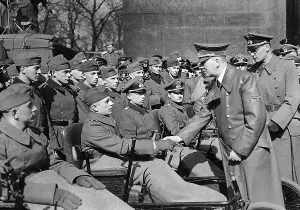 Seriously: Adolf Hitler with war wounded, 1943