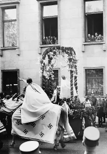 Stretches: Adolf Hitler at the window during a pageant for the First of