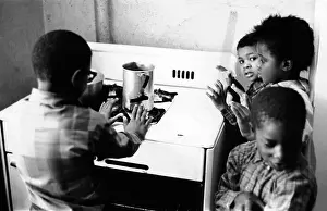 Monoxide: Four African American children cluster around ?