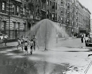 Tntarlcgr: African American children playing in water sprayed
