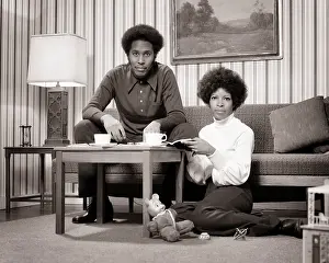 Dollhouse: African-American Couple at Coffee Table Looking