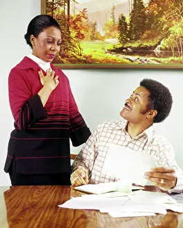 Checkbook: African-American Couple Man Seated at Table Going over