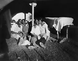 Encampments: Two African American couples in tent, during the