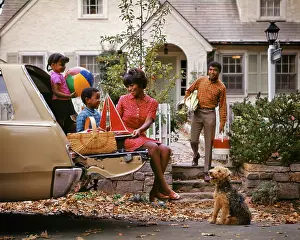 Manly: African American Family of Four Loading Car For