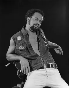 Handlebars: African American man leaning on his motorcycle