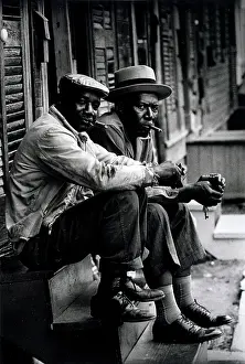 Stoop: Two African American men sitting on stoop, ?