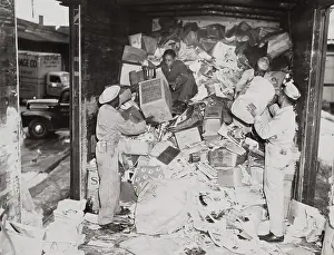 Racially: African American soldiers loading trash on a freight