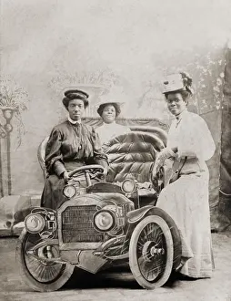 Burroughs: Three African-American women posed with studio prop