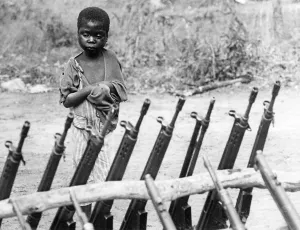 Orphaned: African orphan behind weapons