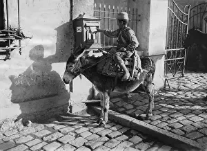 Mailbox: An African posts a letter in the mailbox, 1925