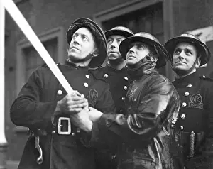 Four AFS firefighters operating hosepipe, WW2