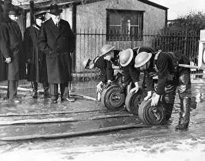 Unrolling: AFS firefighters unrolling hosepipes, WW2