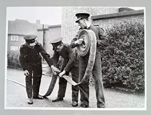 Coiled: AFS volunteers undergoing hose drill, WW2