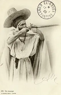 Wide Brimmed: Algeria - An Insurgent aiming his rifle