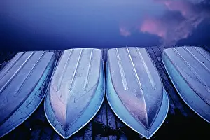 Skiff: Four Aluminum Boats Turned Upside Down on Dock