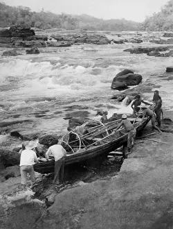 Rapids: Amazon Indians launch their boat, 1938