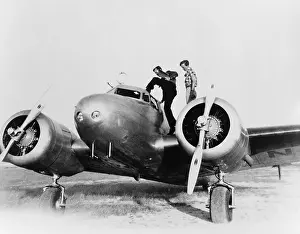 Noonan: Amelia Earhart stanind on the wing of her ?