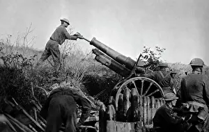 Towed: American artillery soldiers reloading a 155mm