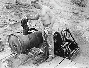 Guinea: American soldier doing his weekly laundry, circa 1942