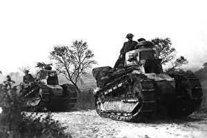 Treads: American troops ride on World War I tanks going