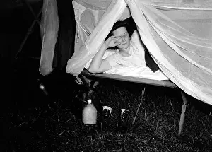 Illuminates: American WAC raises the netting over her cot as