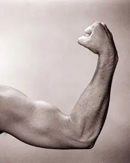 Flexing: Anonymous Man Flexing Arm making a Fist to show Strong
