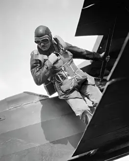 Ripcord: Anonymous Man Standing on Wing of Airplane