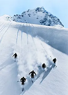 Pristine: Five Anonymous Men Skiing Down Snow Covered Alps