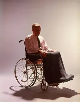 Classic Stock: Anonymous Silhouetted Man Sitting in Wheelchair