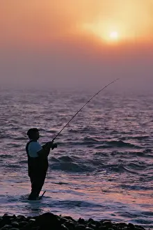 Lga001: Anonymous Silhouetted Man Surf Fishing