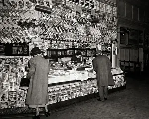 Newsstand: Anonymous Woman and Man Looking at Selecting Purchasing