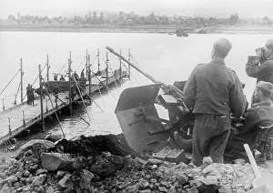Secures: Anti-aircraft gun secures the construction of a bridge over